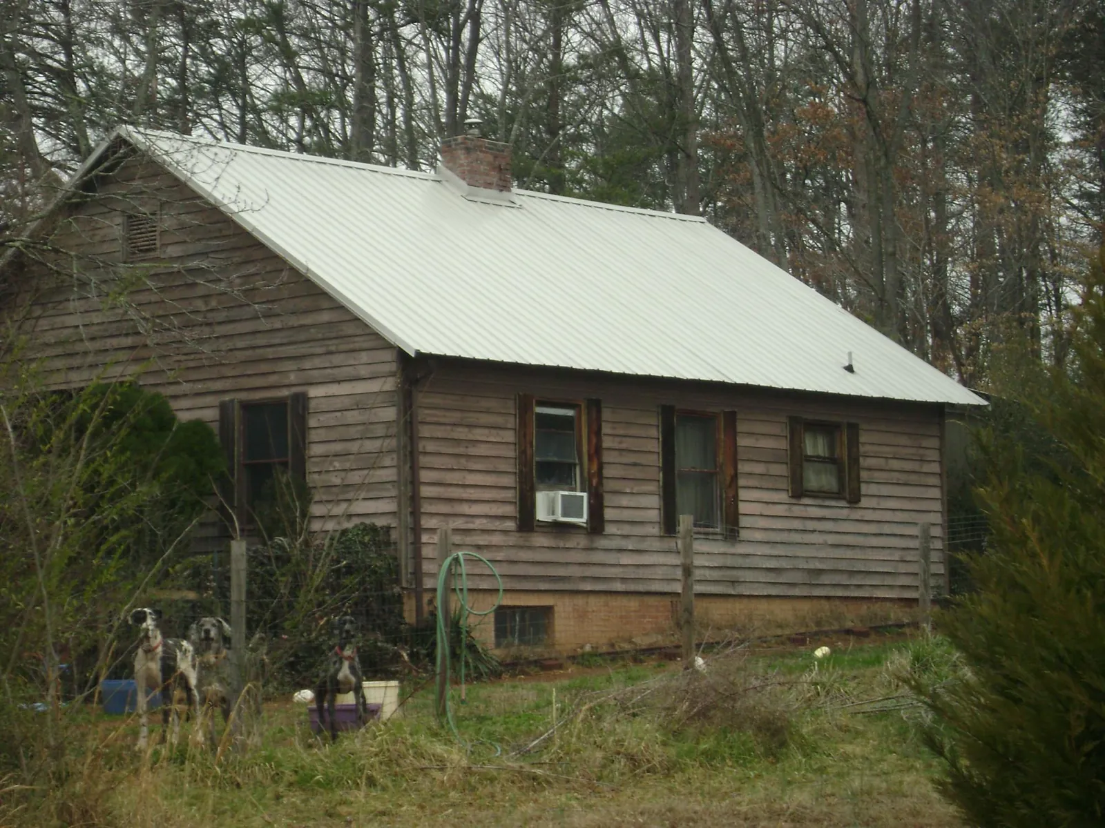 White metal roof on an old wood sided farmhouse, from a Metal Roof Installation job in California